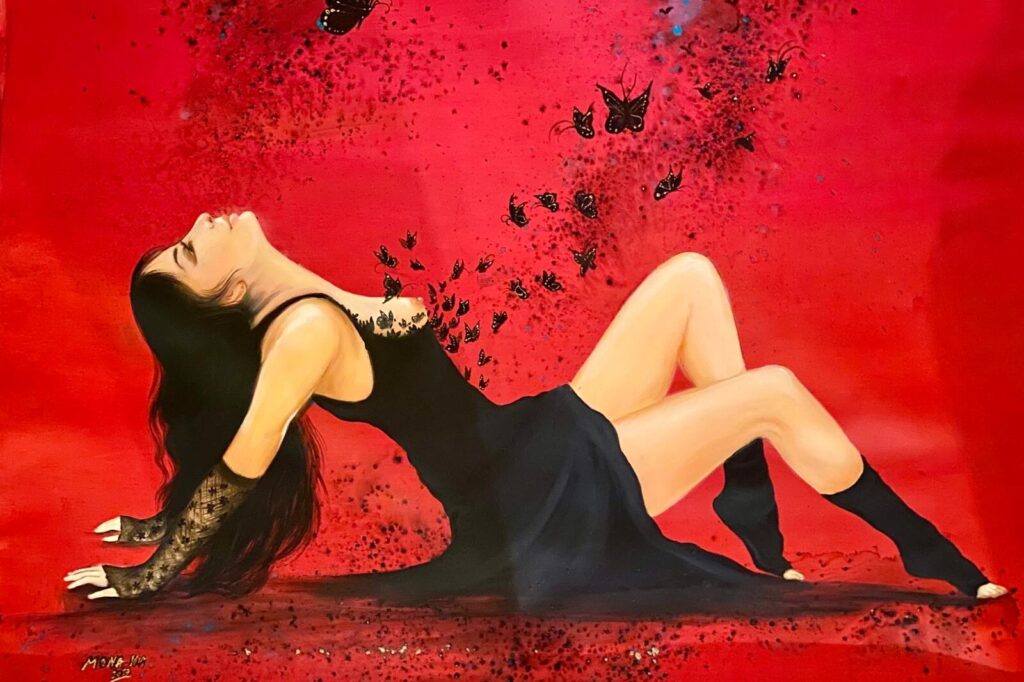 A woman in a black outfit lounges dramatically on a red background with scattered dark butterflies, creating a moody and sensual atmosphere.