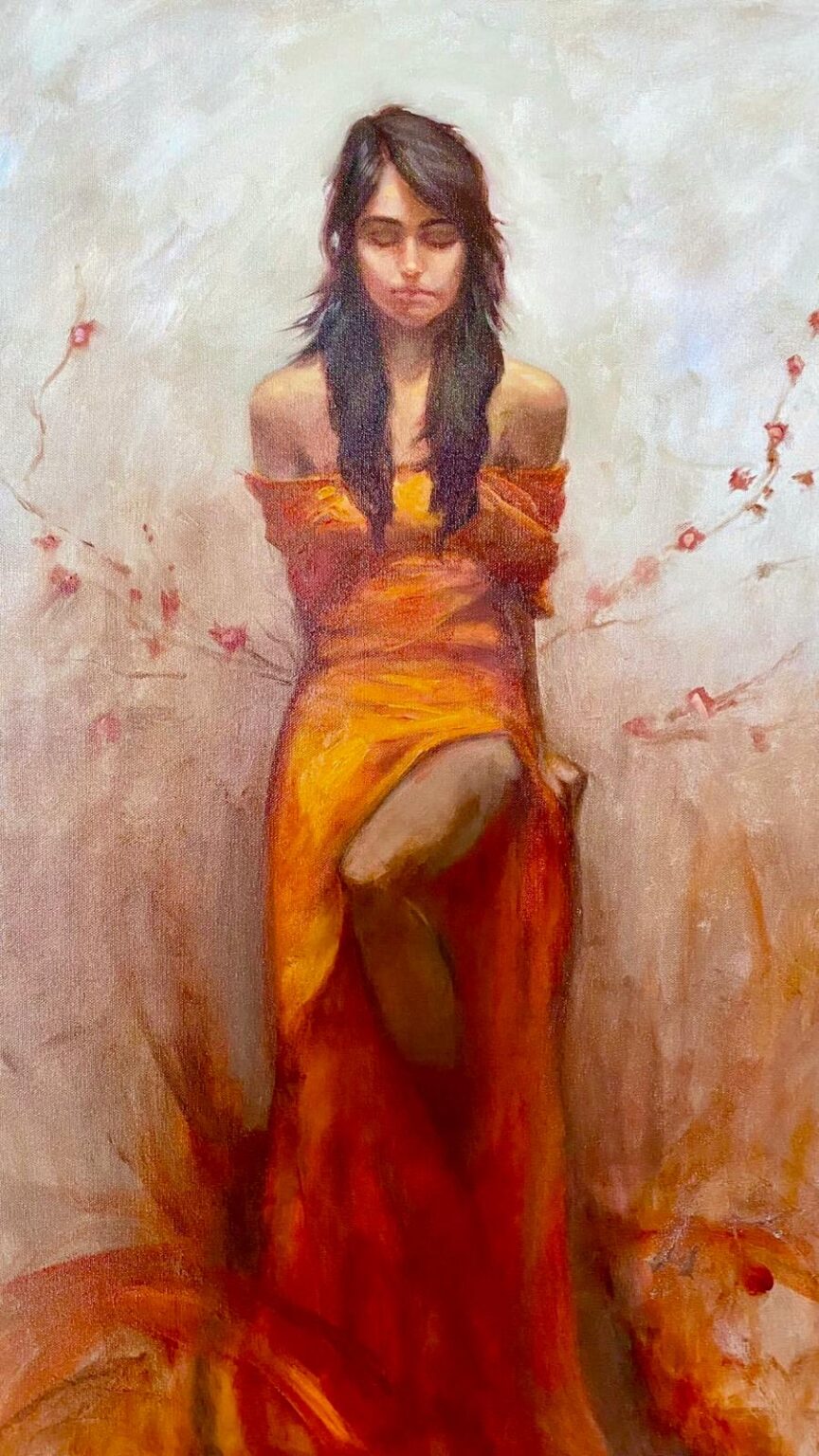 A woman in a flowing orange and red dress stands with her head bowed and eyes closed, surrounded by subtle ember-like branches and warm tones that evoke inner fire.