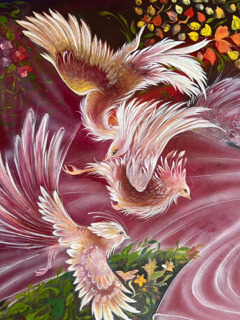Three ethereal birds with flowing wings soaring in a swirling rose-colored sky above foliage and golden leaves.