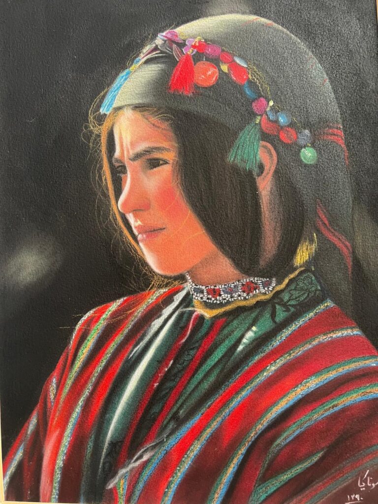 A young woman in traditional highland attire with a colorful striped garment and decorative headpiece gazes thoughtfully into the distance against a dark background.